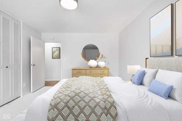 bedroom featuring light carpet and baseboards