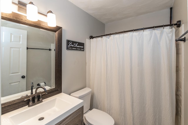 bathroom with toilet, curtained shower, and vanity