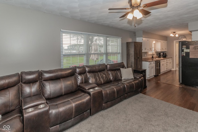 living room featuring dark wood finished floors and a ceiling fan