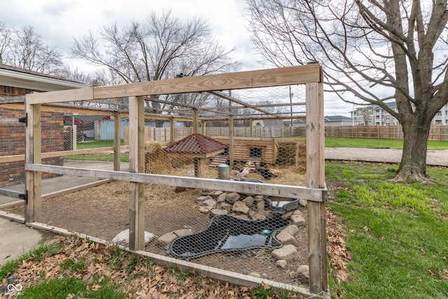 view of patio / terrace featuring fence, exterior structure, and an outbuilding