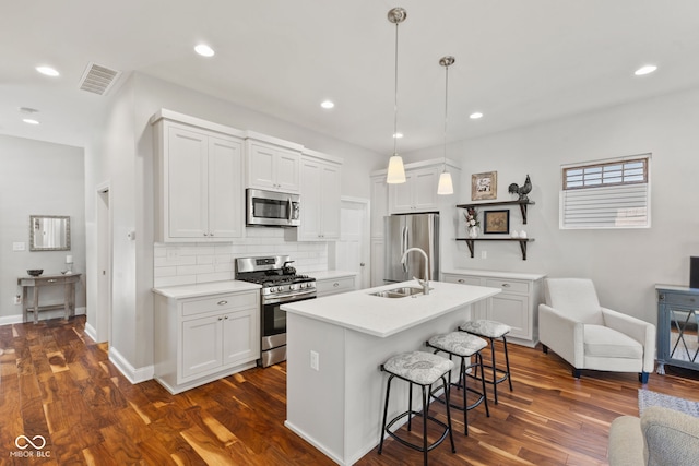 kitchen featuring visible vents, appliances with stainless steel finishes, light countertops, and pendant lighting