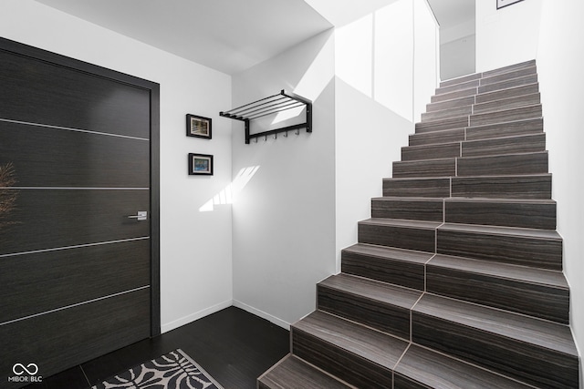 stairs with baseboards and wood finished floors