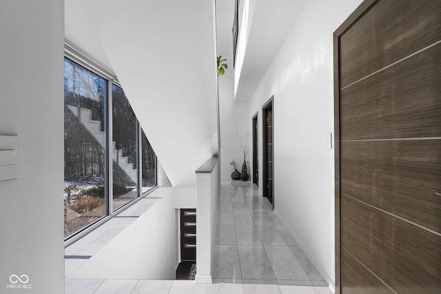 hallway with marble finish floor