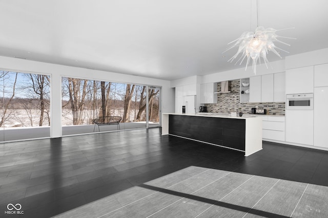 kitchen featuring pendant lighting, open shelves, light countertops, white cabinets, and modern cabinets