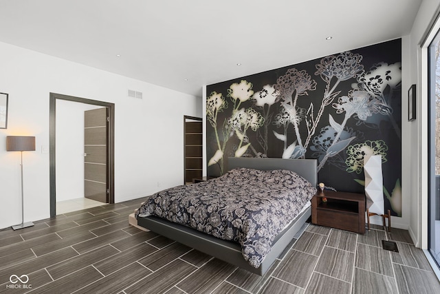 bedroom with wood finish floors and visible vents