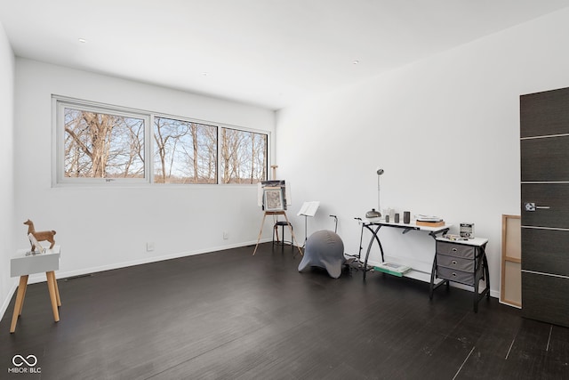 interior space with visible vents, baseboards, and dark wood-type flooring