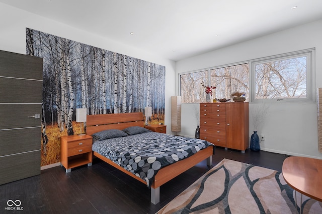 bedroom featuring dark wood-type flooring and baseboards