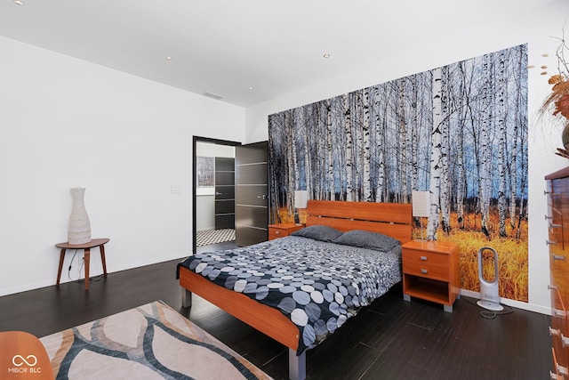 bedroom featuring baseboards, visible vents, and dark wood-style flooring