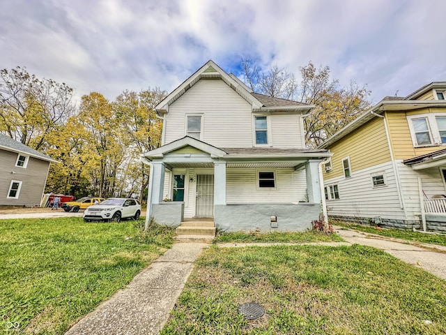 view of front of house with covered porch and a front yard