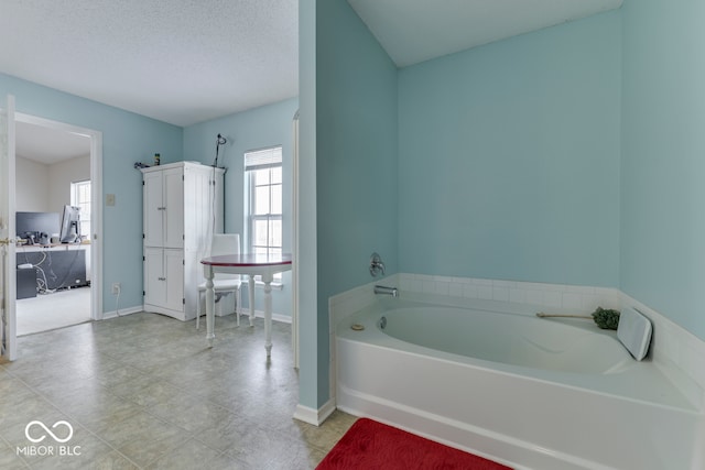 387 Legacy Blvd, Greenwood, IN 46143 - bathroom featuring a bath and baseboards