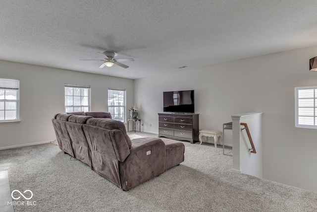387 Legacy Blvd, Greenwood, IN 46143 - carpeted living area featuring a ceiling fan, a textured ceiling, and baseboards