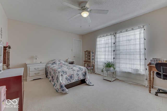 387 Legacy Blvd, Greenwood, IN 46143 - bedroom featuring light colored carpet, a ceiling fan, a textured ceiling, and baseboards