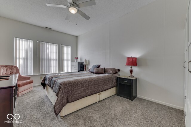 387 Legacy Blvd, Greenwood, IN 46143 - bedroom featuring light colored carpet, a textured ceiling, baseboards, and a ceiling fan