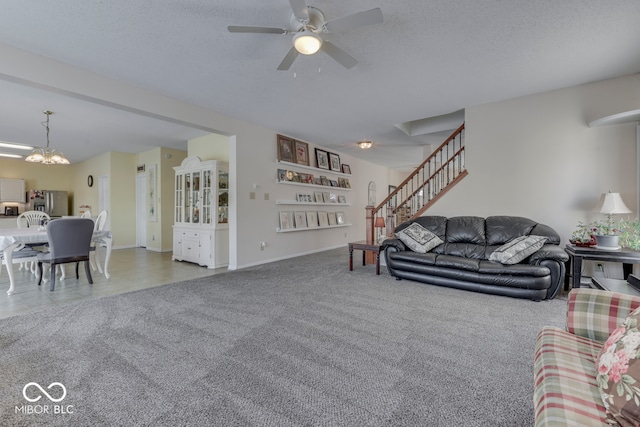 387 Legacy Blvd, Greenwood, IN 46143 - carpeted living room with stairs, a ceiling fan, a chandelier, baseboards, and a textured ceiling