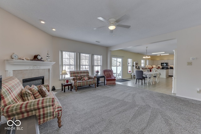 387 Legacy Blvd, Greenwood, IN 46143 - carpeted living area with a tile fireplace, baseboards, ceiling fan, and recessed lighting