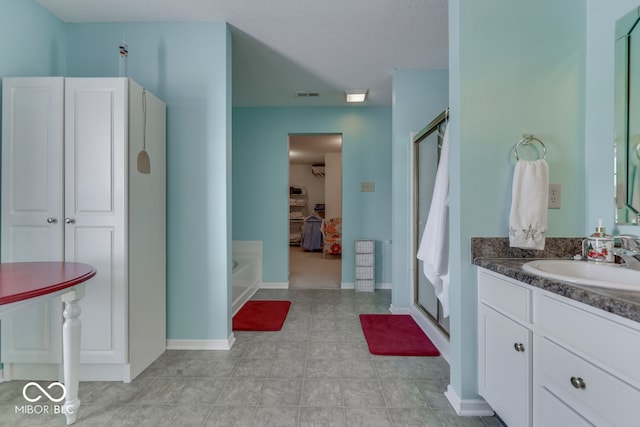 387 Legacy Blvd, Greenwood, IN 46143 - bathroom with vanity, a shower stall, a garden tub, and a walk in closet