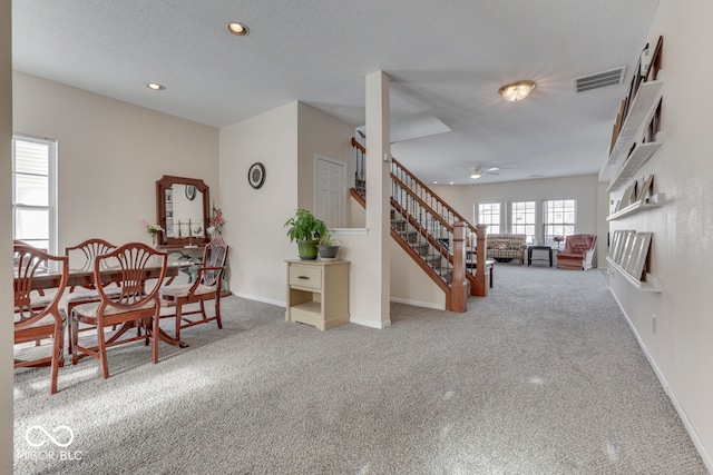 387 Legacy Blvd, Greenwood, IN 46143 - carpeted dining room with ceiling fan, recessed lighting, stairs, baseboards, and a textured ceiling