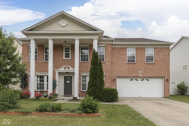 387 Legacy Blvd, Greenwood, IN 46143 - neoclassical / greek revival house with concrete driveway, brick siding, an attached garage, and a front yard