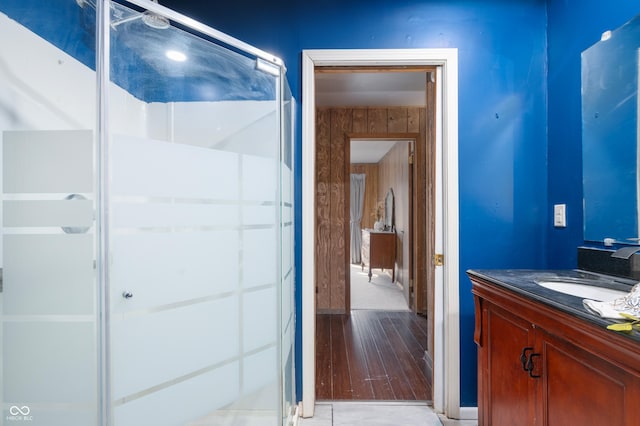 bathroom featuring a shower stall and vanity