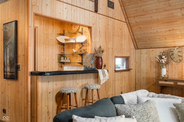 interior space with wooden ceiling, visible vents, vaulted ceiling, and a dry bar