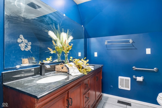 bathroom featuring visible vents, a sink, toilet, and double vanity