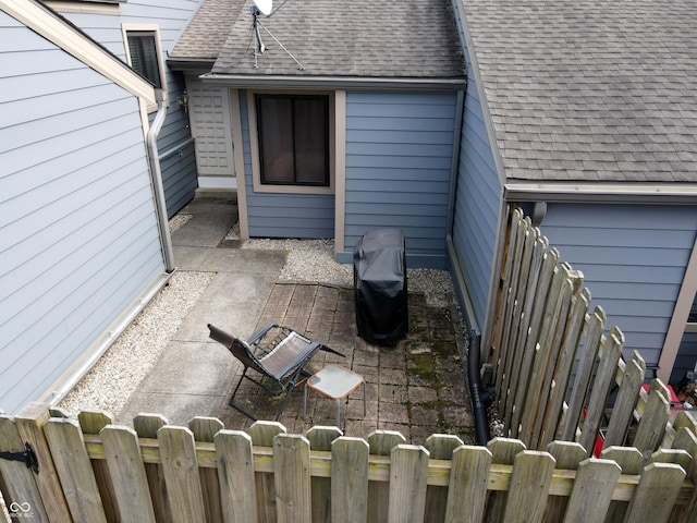 view of patio / terrace featuring a grill and fence