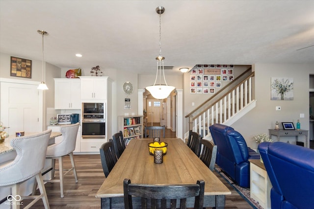 dining room with dark wood-style floors, stairway, and recessed lighting