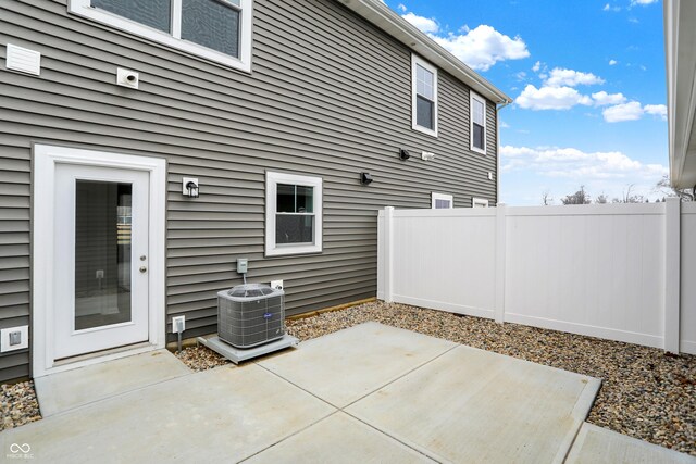 view of patio featuring central AC and fence