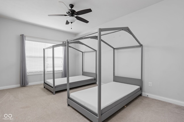 unfurnished bedroom with a ceiling fan, light colored carpet, and baseboards