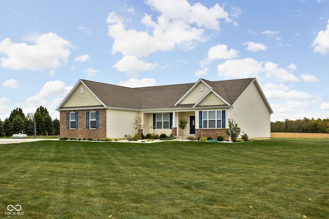 view of front of house featuring a front yard and brick siding