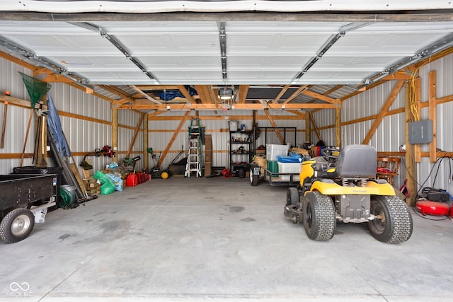 garage featuring metal wall and a garage door opener