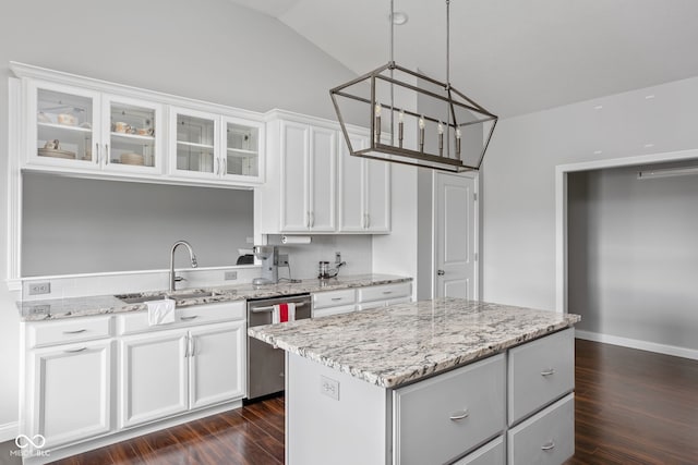 kitchen featuring white cabinets, dishwasher, a kitchen island, glass insert cabinets, and a sink