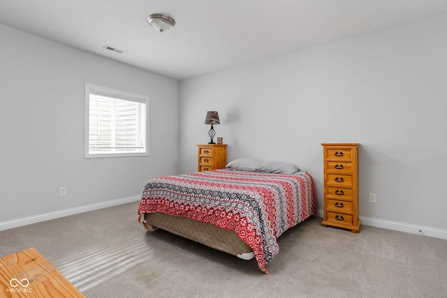 carpeted bedroom with visible vents and baseboards