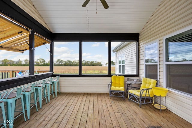 sunroom with lofted ceiling and ceiling fan