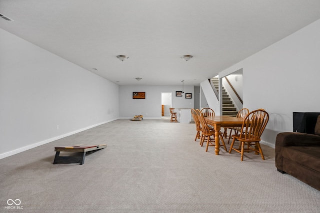 dining room with stairway, carpet, and baseboards