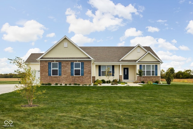 view of front of home featuring brick siding, a front lawn, and a porch