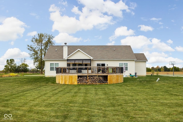 rear view of house featuring a deck and a yard