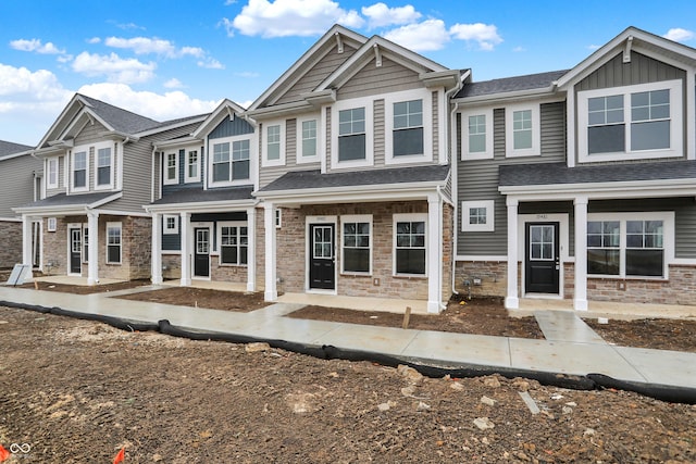 view of front of house with stone siding and board and batten siding