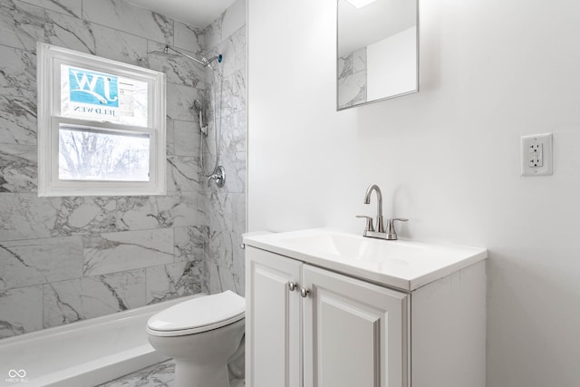 full bath featuring marble finish floor, a tile shower, toilet, and vanity