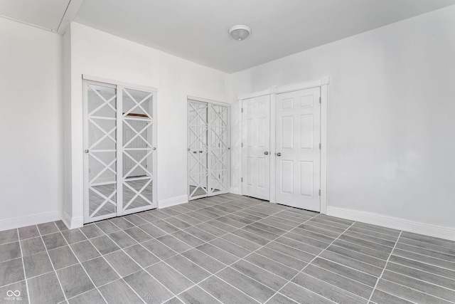 unfurnished bedroom with baseboards