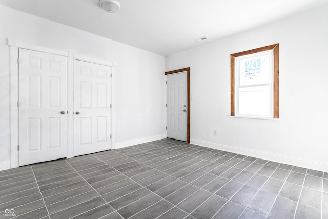 interior space with baseboards and visible vents