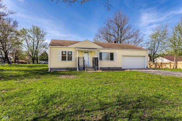 view of front of home with a front lawn, driveway, a chimney, fence, and an attached garage