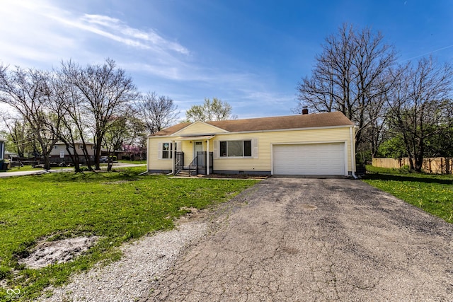 ranch-style house with crawl space, a front lawn, aphalt driveway, fence, and a garage
