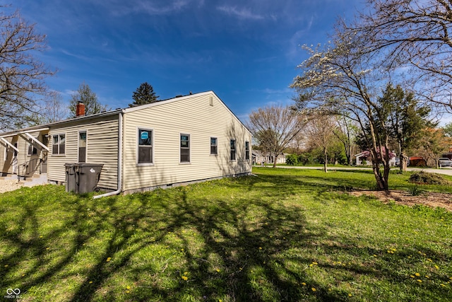 view of side of property with a lawn and a chimney