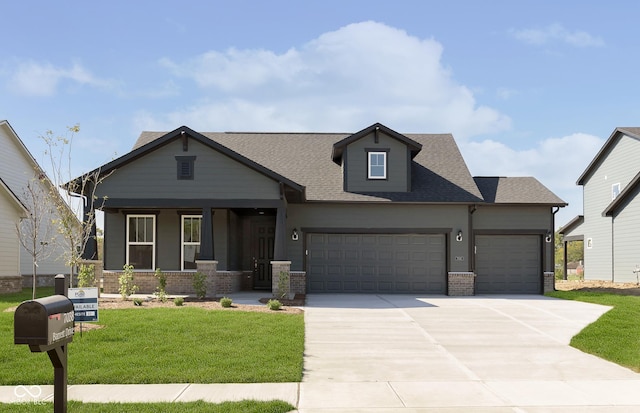 view of front of home with a porch, an attached garage, brick siding, driveway, and a front yard