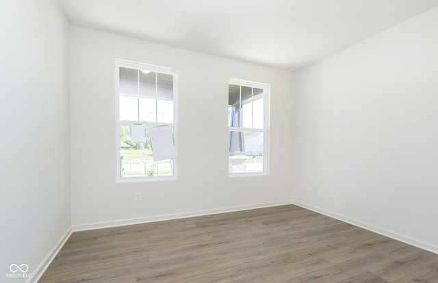 empty room with wood finished floors and baseboards