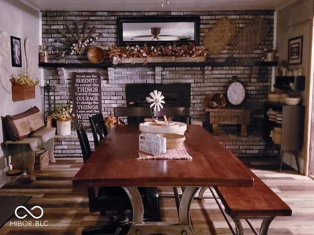 bar with a fireplace and wood finished floors