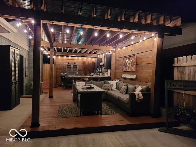 deck at twilight featuring a pergola, fence, and an outdoor hangout area