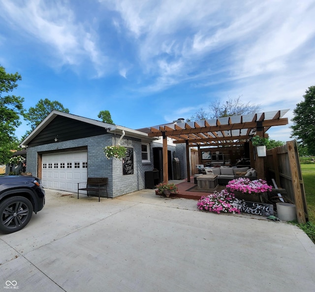 view of front facade with brick siding, an attached garage, an outdoor hangout area, a pergola, and driveway