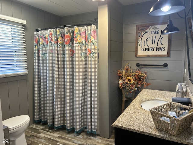 full bathroom with vanity, curtained shower, wood finished floors, and toilet